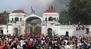 Youth protesters in Kathmandu wave national flags during the 2025 Gen Z uprising.