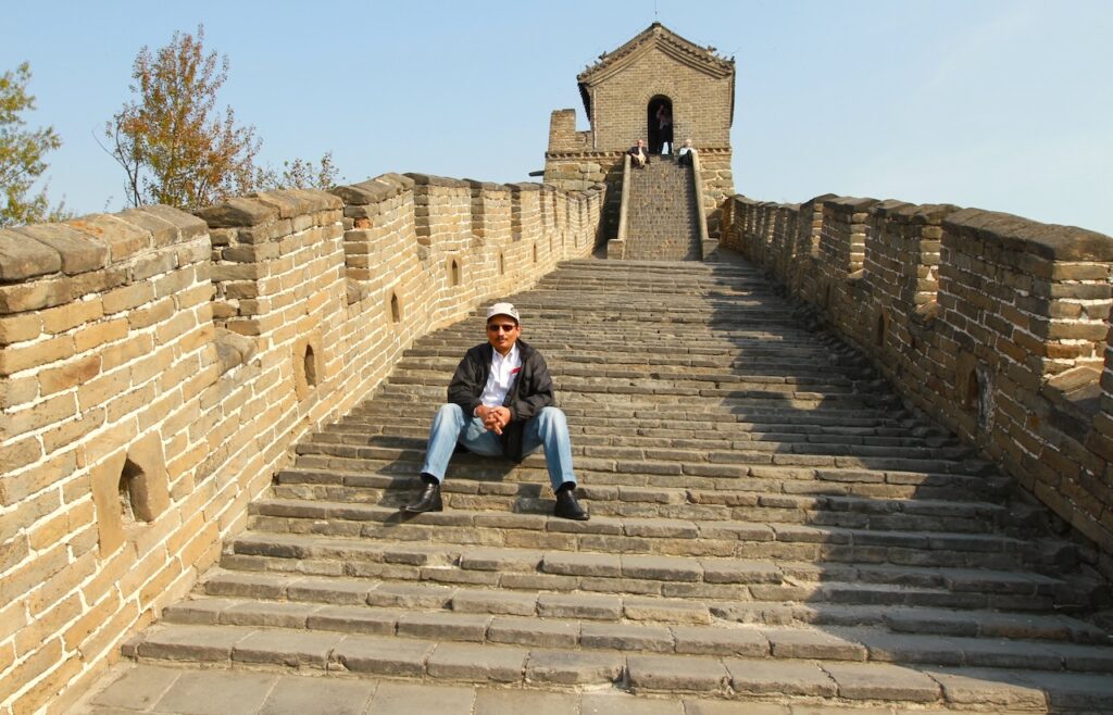 Climbing stone steps to a watchtower on The Great Wall of China at Mutianyu