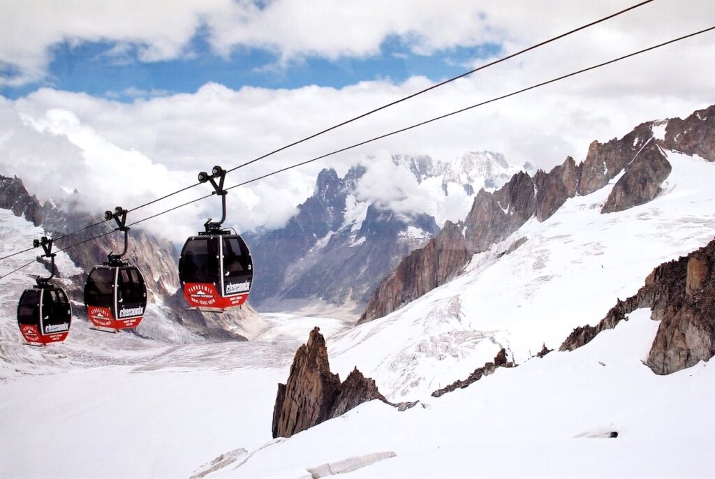 The Panoramic Mont-Blanc gondola cabins crossing above a glacier valley between Aiguille du Midi, France and Pointe Helbronner, Italy is the 7th Highest Ropeway Systems in the World