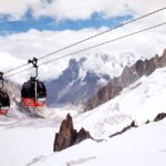 The Panoramic Mont-Blanc gondola cabins crossing above a glacier valley between Aiguille du Midi, France and Pointe Helbronner, Italy is the 7th Highest Ropeway Systems in the World
