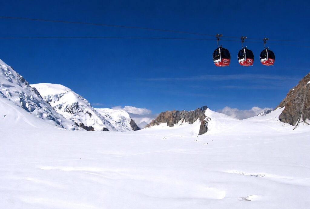Panoramic Mont Blanc gondolas crossing glaciers between France and Italy in the Mont Blanc Massif.