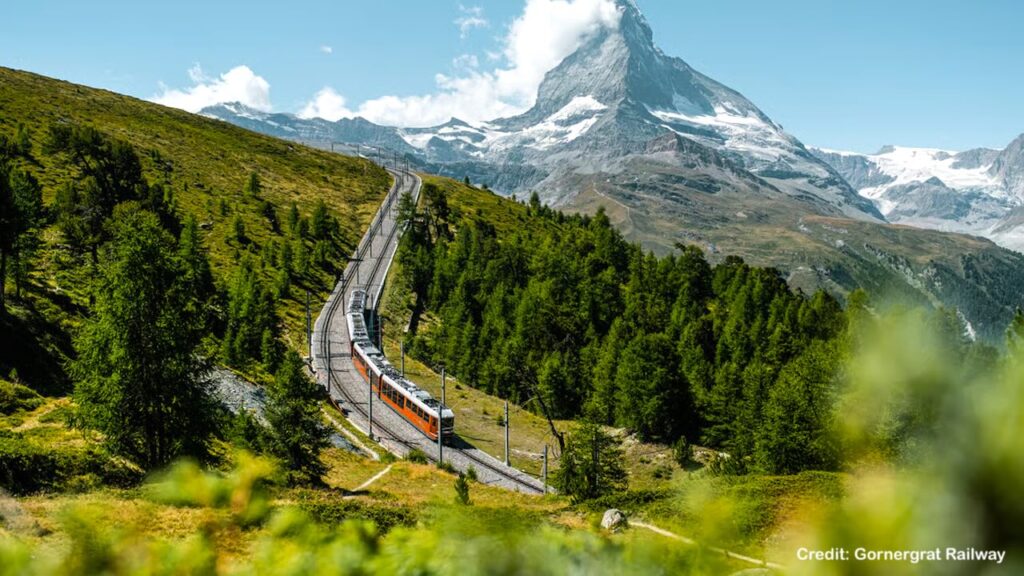 Gornergratbahn train curving towards Riffelalp with Matterhorn in summer